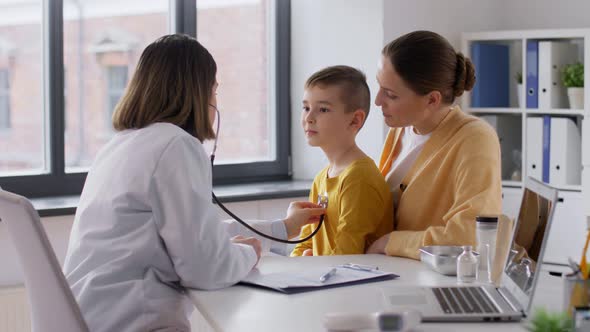 Mother Son and Doctor with Stethoscope at Clinic