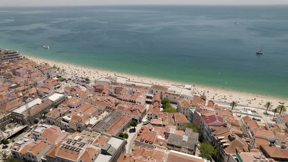 Sesimbra beach in summer season, Portugal. Aerial orbit
