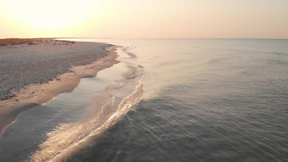 Aerial View of Sandy Beach and Ocean with Waves