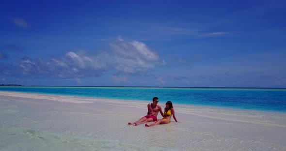 Happy couple in love dating on vacation enjoy life on beach on summer white sandy background 4K