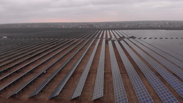 Aerial Drone View Into Large Solar Panels at a Solar Farm at Cloudy Autumn Day, Solar Cell Power