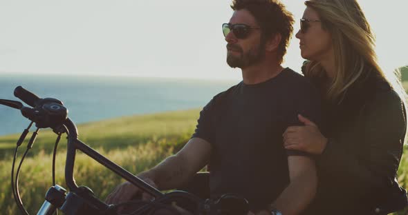 Couple on Motorcycle Watching the Sunset