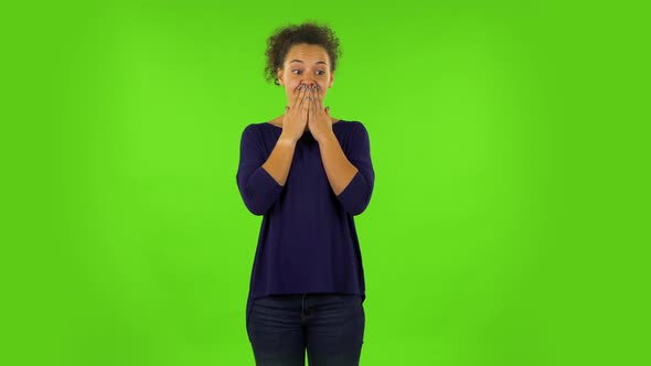 Curly Woman Disappointed Looking in Camera Biting Her Lips. Green Screen