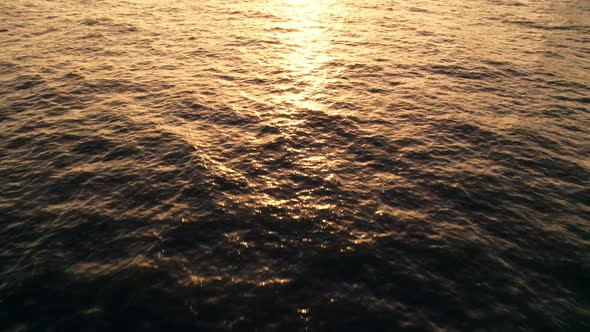 Drone aerial view dolly side panning over paradise beach sunrise.