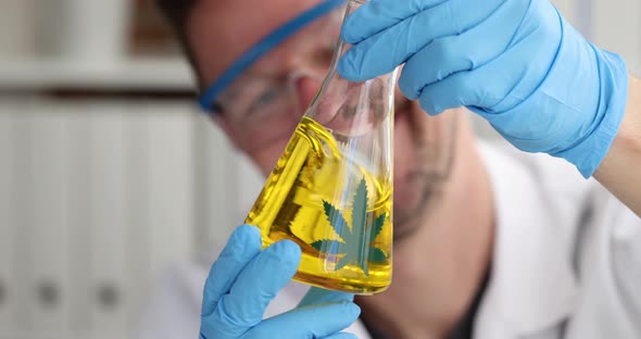 Scientist with Gloves Cracks Glass of Marijuana Oil in Laboratory Slow Motion  Movie
