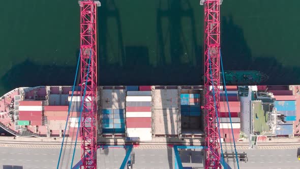 Drone Flying Over a Container Ship During Cargo Operations Over the Customs Area