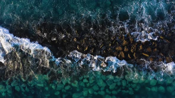 Top View of the Surface of the Atlantic Ocean Near the Coast - Waves Roll Through the Breakwater