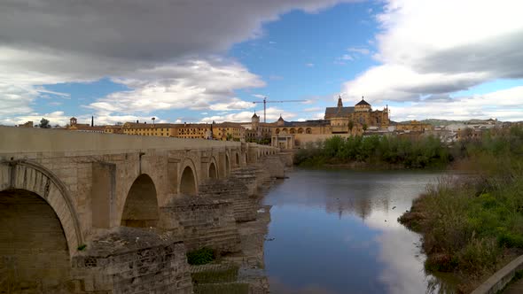 Wide open view over Córdoba river with Mezquita, blue and cloudy sky