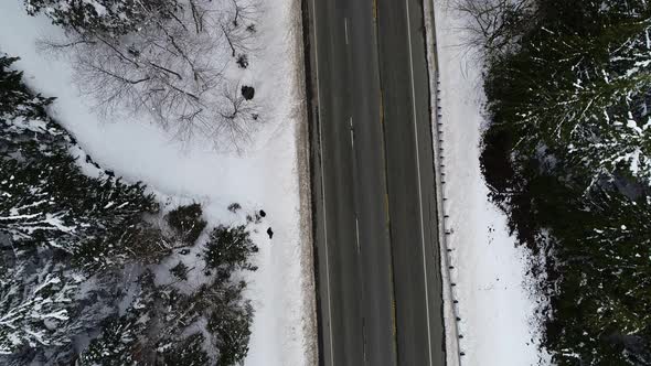 Vehicles Driving Mountain Highway Snow Top Down Aerial View