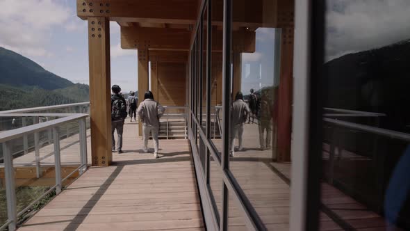 Tourists walking on Boardwalk with their reflections in window