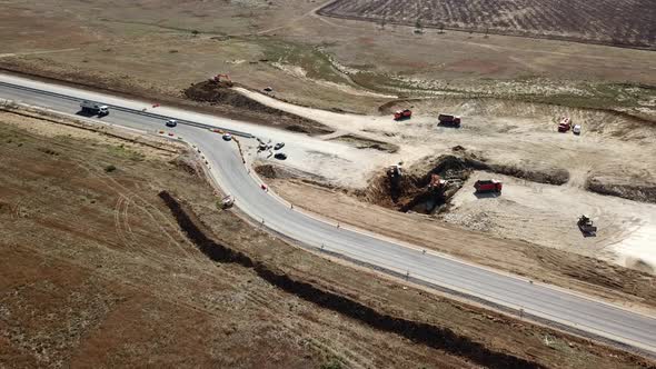 Aerial Road Constructions, Machinery and Mine Equipment Near Road on Sandy Surface alt
