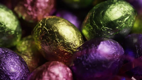 Rotating shot of colorful Easter candies on a bed of easter grass - EASTER