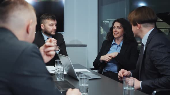 Female Executive Discussing New Project with Colleagues at Business Meeting