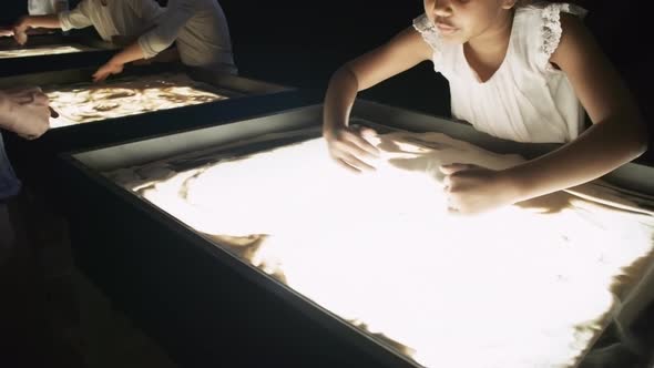 Cute Little Girl in Sand Animation Class