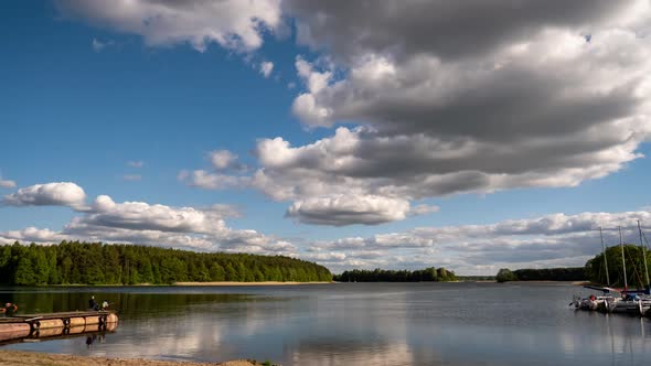 Time Lapse. Clouds and Blue Sky Over Lake.  