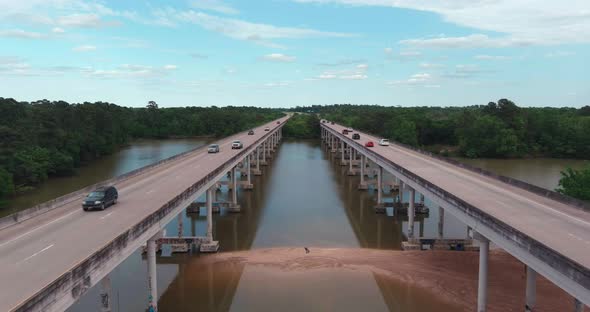 Aerial of cars driving on bridge that crosses over the San Jacinto River in Houston, Texas