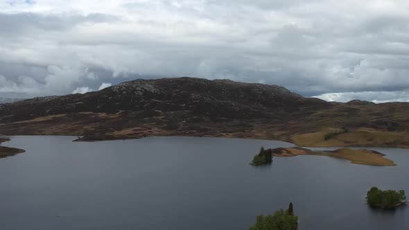 Tilt-down droneshot of scottish higland lake island