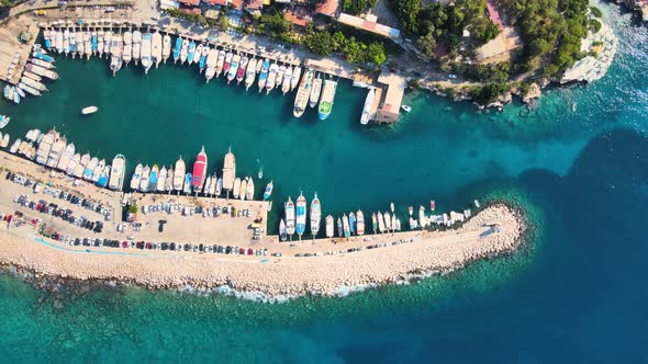 Close-up drone flight over the water surface of the yacht, boats and cars in the background of the r