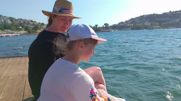 Woman And Girl On Sea Pier