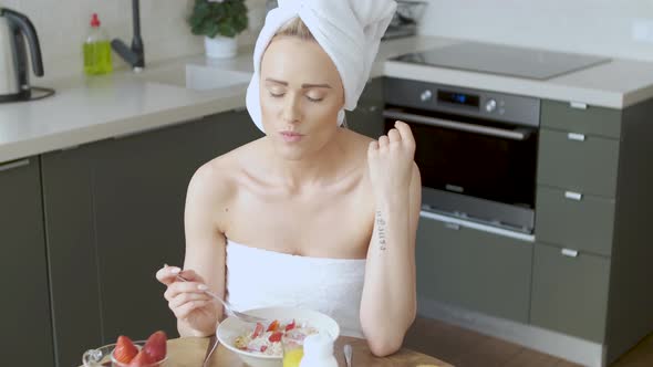 Beautiful Middle Aged Woman Sitting in Her Kitchen in the Morning