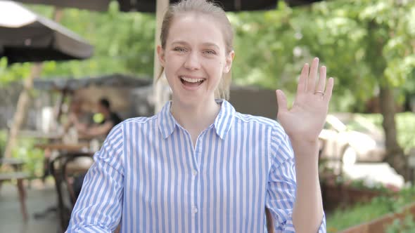 Hello by Young Woman Sitting in Cafe Terrace