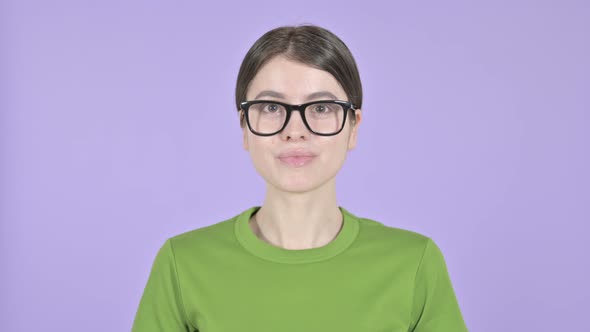 Successful Young Woman Showing Thumbs Up on Purple Background