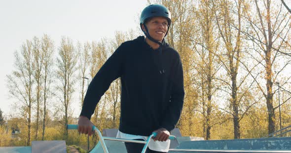 Entertaining Student Spending Active Time After College Walking Through Skatepark Leading Bike