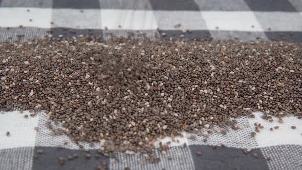Chia Seeds Falling and Landing Spread in to a Large Pile