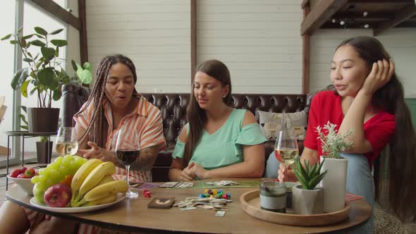 Beautiful Friends Enjoying Pastime Playing Game in Modern Apartment