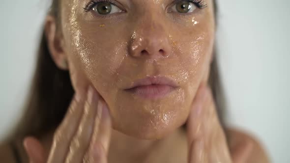 A Young Beautiful Girl Applies a Transparent Moisturizing Mask to Her Face