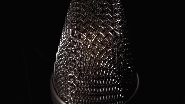 Studio Condenser Microphone Rotates on Black Background