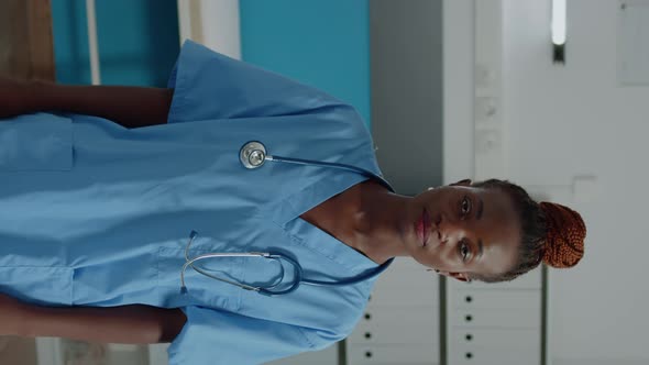 Vertical Video Portrait of Medical Nurse Looking at Camera in Cabinet