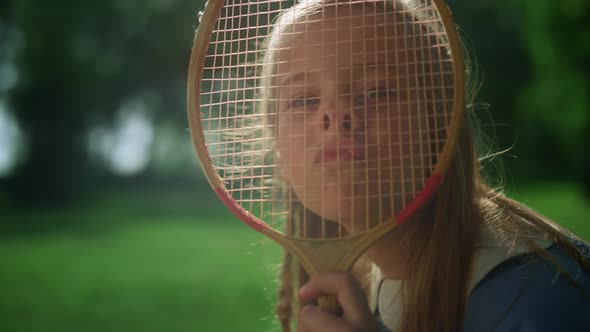 Jjoyful Girl Making Funny Faces with Badminton Racket in Summer Park Closeup