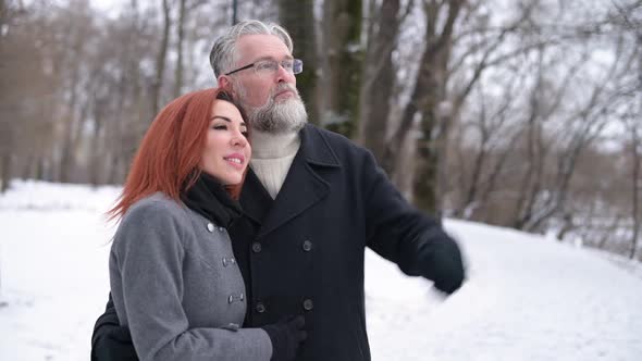 Husband and wife walk in the park and enjoy the views, contemplate the landscape