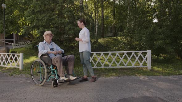 Nursemaid Talks with the Man in Wheelchair