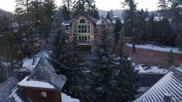 Luxurious Mansion between Christmas Pine Trees, Big Bear Lake Town, California, Morning Winter Snowf