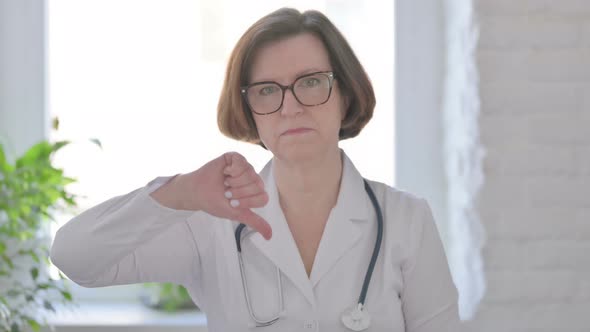 Senior Female Doctor Showing Thumbs Down Gesture