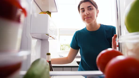 Woman Taking Apple From Fridge at Home Kitchen