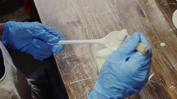 Glazing clay spoon with brush