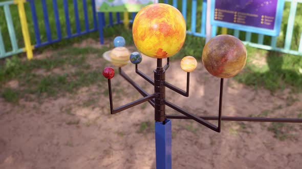 Boy is Playing and Studying a Mockup of a Solar System