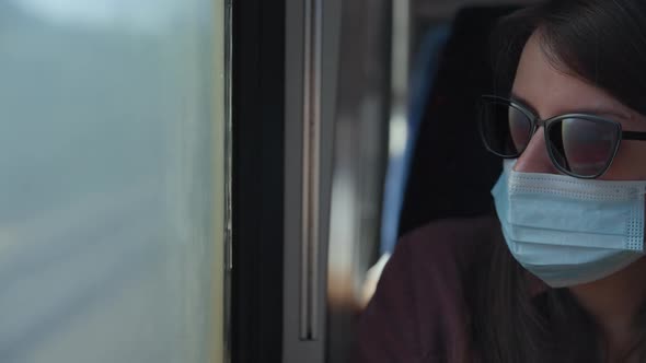 Woman in a medical mask on a train