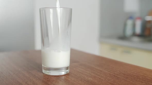 Milk is Poured into Transparent Glass