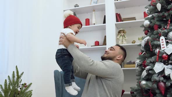 Loving Dad Throwing Up in the Air His Incredible Cute Smiling Toddler