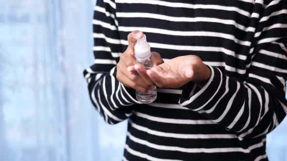 Close Up of Young Man Hand Using Hand Sanitizer Spray