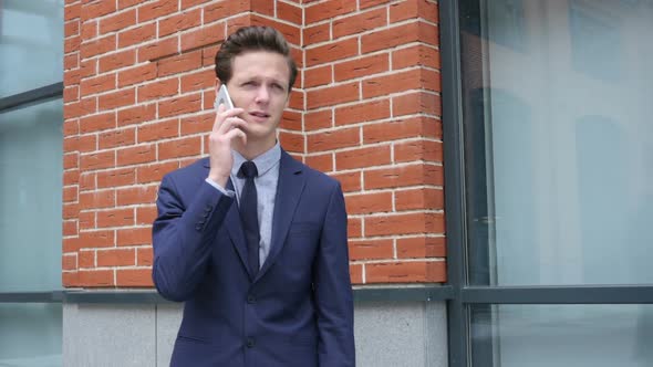 Businessman Talking on Phone with Partner, Close Up, Outdoor