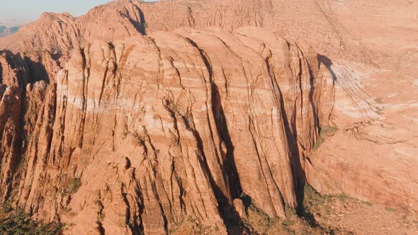 Panning aerial of Utah's desert mountains in the Summer heat.