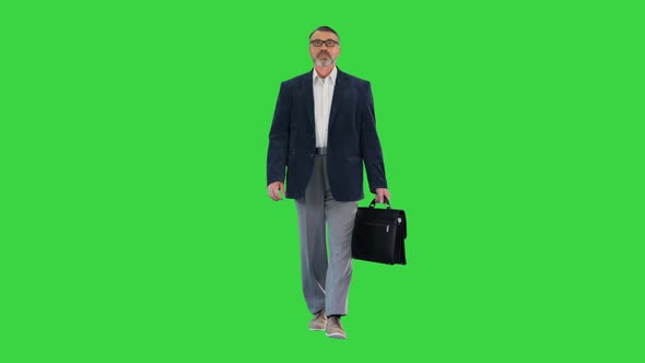 Senior Business Man Walking with Briefcase on a Green Screen Chroma Key