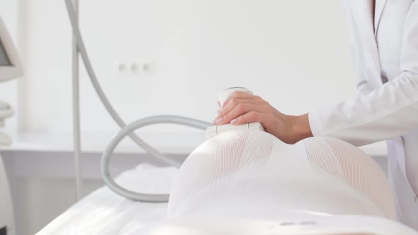 Female Doctor Hands Holding a Modern Medical Equipment for Body Skin Massage and Treatment.