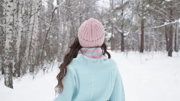 Stylish Young Woman Walking Towards Winter Forest