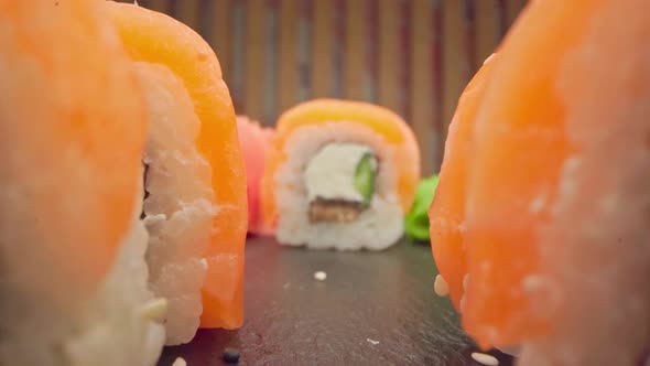 Zoom in Slide Video of Japanese Sushi Roll on Wooden Background